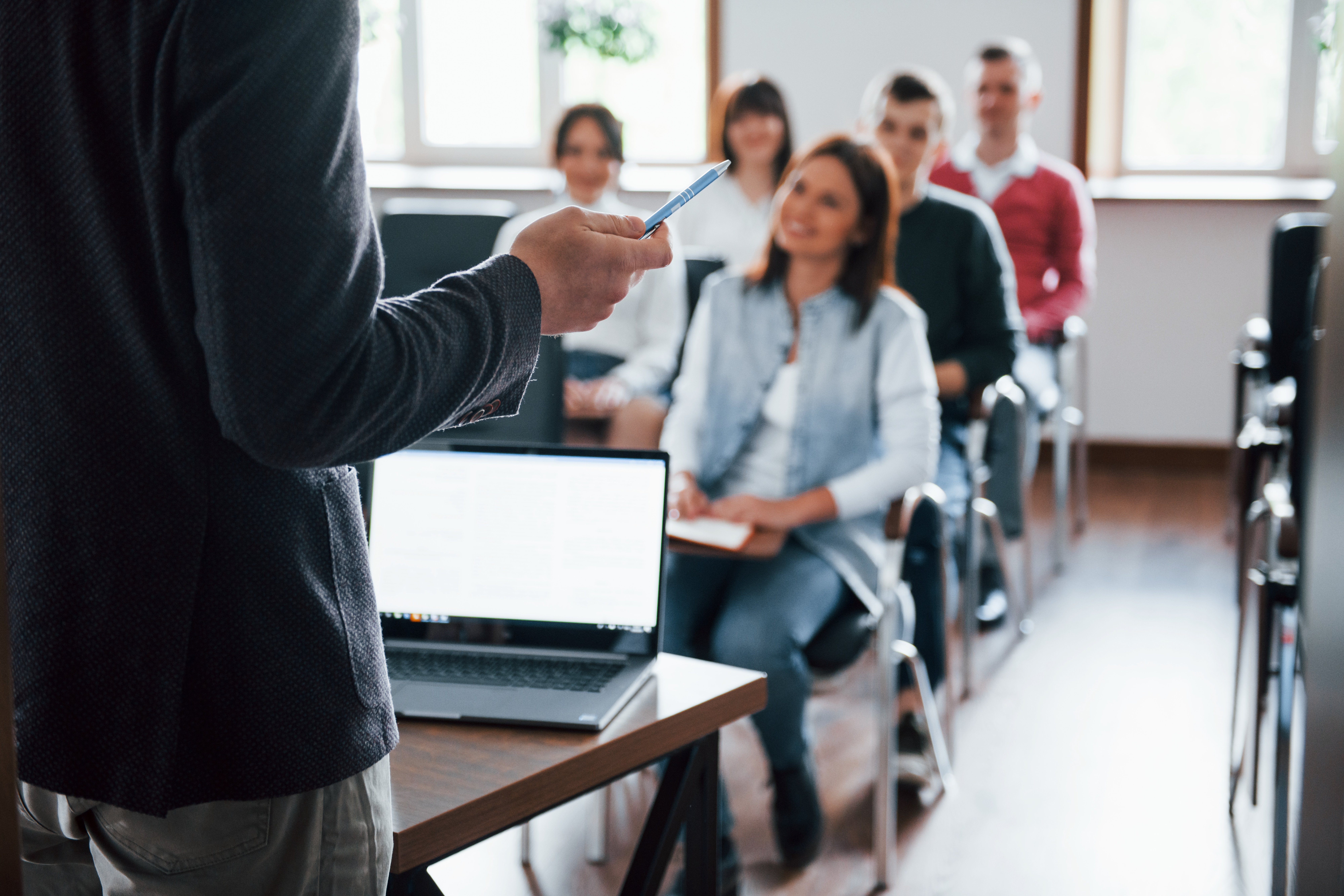 Business trainer presenting to a classroom